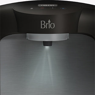 Close-up of a Brio water dispenser with a gray metallic finish, showing a light shining down from the spout area, illuminating the space below.